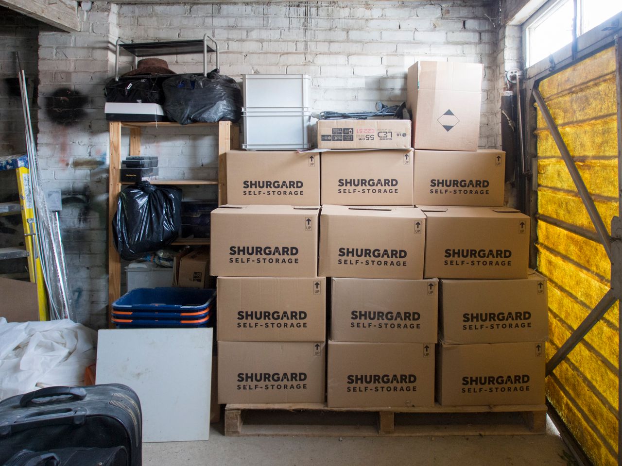 A stack of storage boxes in a neatly arranged warehouse interior.