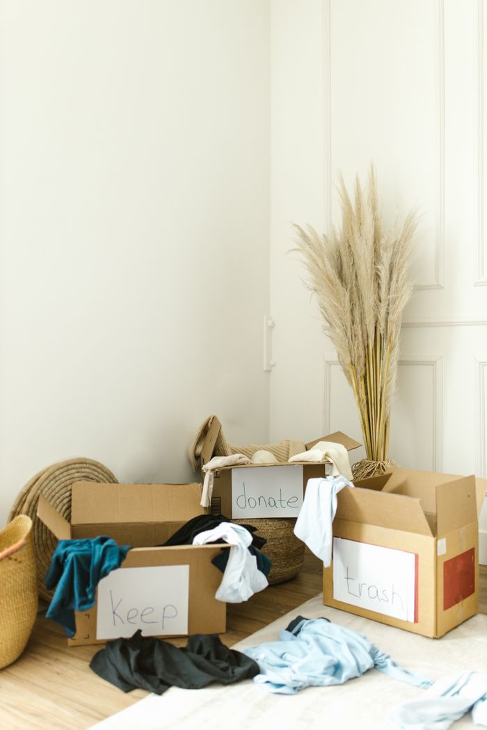 Boxes marked keep, donate, and trash for streamlined home decluttering and organization.